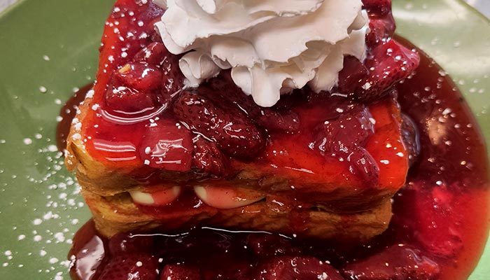 Pine Cone Café stuffed French toast topped with strawberries and whipped cream